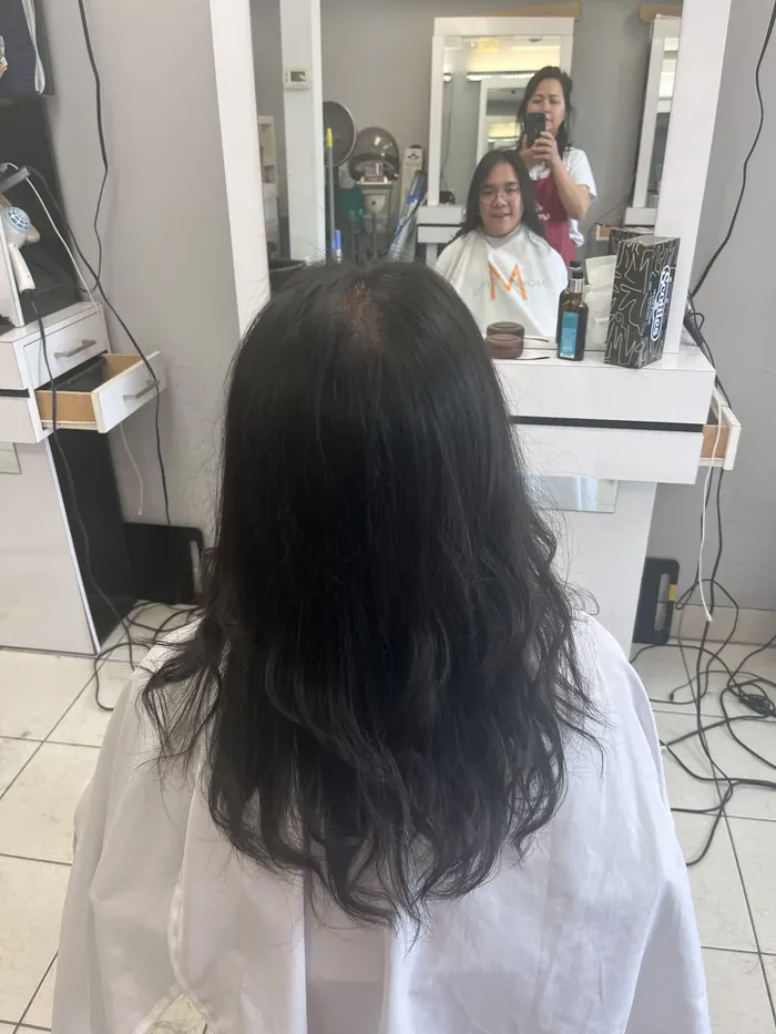 Freshly styled shoulder-length waves, seen from behind